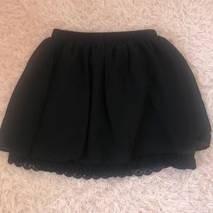 Black flowy skirt with lace at bottom on skirt
